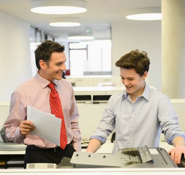 Two employees at a printer